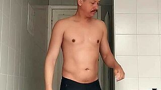 check out this sexy guy in black beach shorts hitting the bathroom for a close shave routine