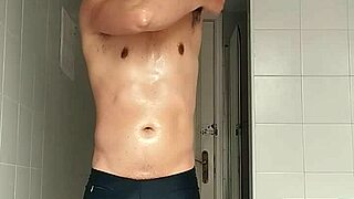 check out this sexy guy in black beach shorts hitting the bathroom for a close shave routine