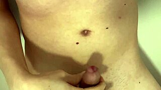 Naked babe spreads legs pees in bathtub stroking hard cock closeup wet