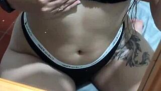 Sexy latina in lingerie plays with her belly button teasing natural tits