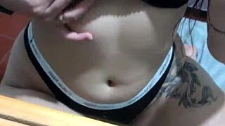 Sexy latina in lingerie plays with her belly button teasing natural tits