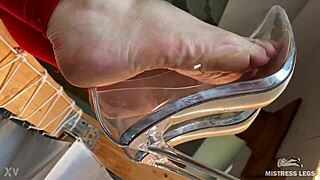 she dangles see-through high heels on wrinkled bare feet up close for foot fetish tease