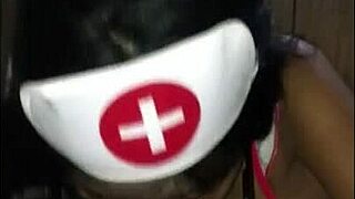 Young Latina nurse cares for patient in hospital room