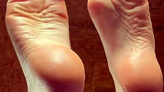 girl rubs lotion slowly over her soft pretty feet casually