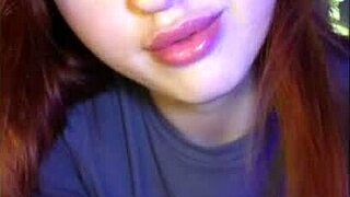 a redhead with blue eyes rides dildo in net while handling cum