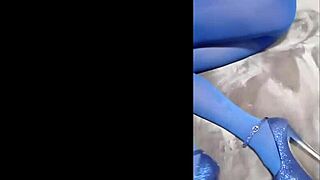 Sexy babe slips into pantyhose with blue high heels