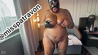 Ebony shemale jerks 70-inch ass in latex hood