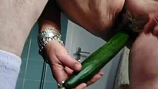 granny stuffs cucumber deep into her hairy german beaver on camera.