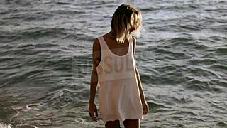 russian blonde in wet see-through bra on salty beach