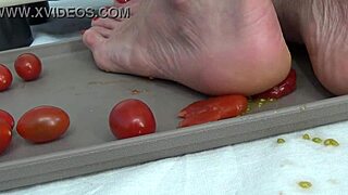 Housewife tramples tomatoes with her feet