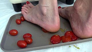 Housewife tramples tomatoes with her feet