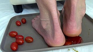 Housewife tramples tomatoes with her feet